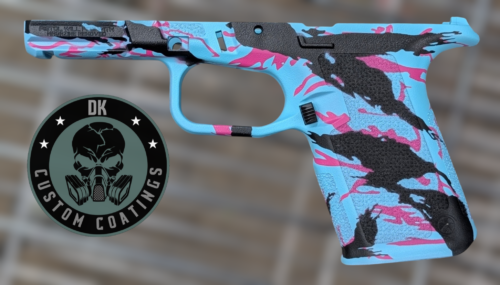 Semi-automatic pistol with blue and pink camouflage finish and black grip, shown beside a circular DK Custom Coatings logo.